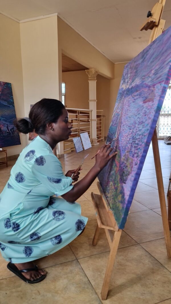 painter squatting to paint in blue dress Stillness in Motion - what the Tide Remembers